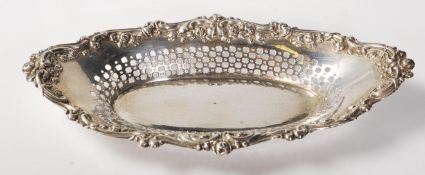 A silver hallmarked pin tray with pierced decoration and floral swag border. Hallmarked for