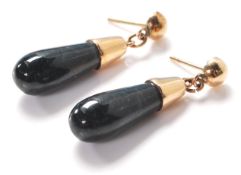 A pair of ladies 14ct gold drop earrings being set with polished green hard stone drops. Earring