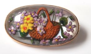 A late 19th / early 20th Century Essex crystal brooch of oval form being reverse carved and