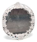 A stamped 925 silver framed easel back dressing table small mirror having raised floral borders with