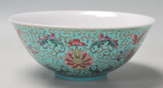 A vintage 20th Century Chinese bowl decorated with floral, butterfly and Shou emblem designs on a