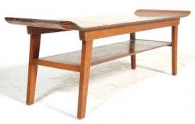 A retro vintage, mid cenutry teak surfboard style coffee occasional table. The table having raised