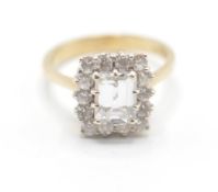 A 9ct gold and white stone cluster ring having a central rectangular cut white stone with a halo