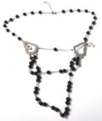 A Swarovski rosary style necklace having spherical ebonised beads on a cable chain with twin glass