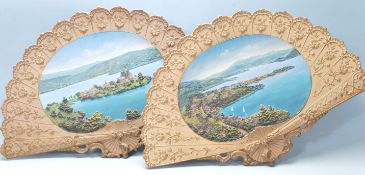 Two 20th Century ceramic wall mounting fans / chargers each having moulded raised decoration with