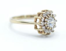 A hallmarked 9ct gold white stone cluster ring being set with a central round cut white stone and
