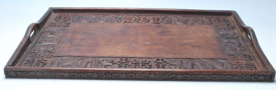 An early 20th Century Chinese Qing Dynasty style carved hardwood rice wine serving tray decorated