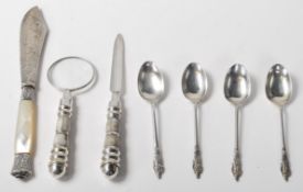 A collection of silver items to include hallmarked silver apostle spoons, a white metal and mother