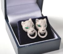A pair of sterling silver and CZ Cartier style earrings having the iconic 