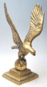 A 20th Century cast brass decorative ornament in the form of an eagle having spread wings raised