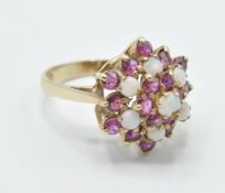 A hallmarked 9ct gold red stone and opal cluster ring having a cluster of round stones to the