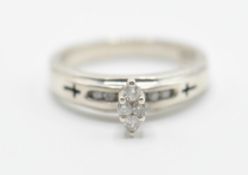 A stamped .925 silver ladies dress ring having a marquise shaped diamond with further diamond accent