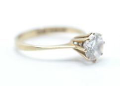 A hallmarked 9ct gold solitaire ring having a prong set round cut white stone. Hallmarked London
