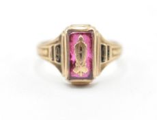 A 9ct gold mid 20th Century class graduation ring having a central rectangular cut pink stone with