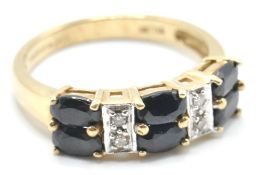 A hallmarked 9ct gold ladies ring being set with six oval cut blue stones with white accent stones