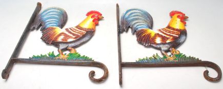A pair of vintage 20th century cast iron cockerel / rooster wall mounted flower basket brackets.