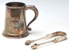 An English silver hallmarked tanker with scroll handle and tapered form being stamped B. D.