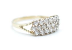 A hallmarked 14ct gold ring being set with three rows of round cut CZ's. Assay marked for