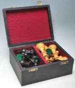 A 20th Century carved chess set having boxwood and ebonised weighted pieces complete with a