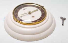 A 1950's mid century retro vintage french wall clock by SML in a bakelite and brass case. Having a