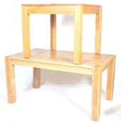 A pair of original contemporary light oak dining tables of Oak Furniture Land style. One of square