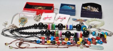 A collection of vintage original costume jewellery to include necklaces, brooches , bookmarks,