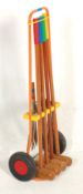 A mid century retro vintage 1950s portable croquet set having multi coloured croquet mallets,