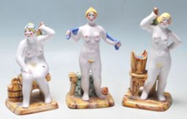 A group of three 20th Century ceramic Russian figurines depicting three stylised nudes ladies each