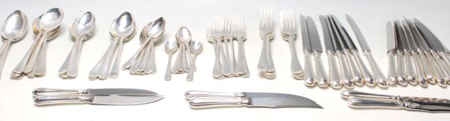 A 20th Century United Cutlery silver cutlery canteen appointed with silver forks, spoons and