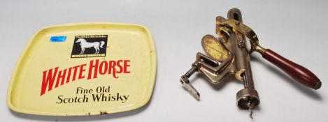 A vintage retro bar top corkscrew having metamorphic action, brass coloured and wooden handle,