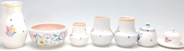 A group of seven vintage Poole Pottery items comprising; a jug, bowl, pair of vases, sugar bowl,