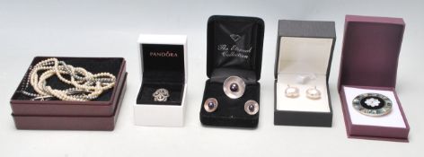 A collection of ladies jewellery to include a silver ring and earring set all being set with black