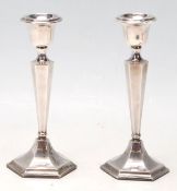 A pair of 20th Century 1920's silver hallmarked candlesticks having hexagonal bases with tapering