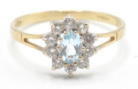 A hallmarked ct gold ladies ring having a central oval cut blue stone with a halo of white stones