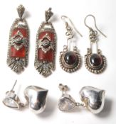 A selection of silver antique earrings to include a pair of Art Deco drop earrings having red