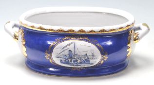 A Staffordshire blue and white ceramic foot bath with twin handles, transfer print panel at the