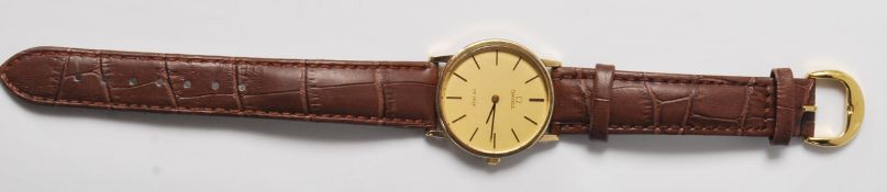 A vintage gentleman's Omega De Ville 9ct wrist watch having a silver brushed dial with gilt baton