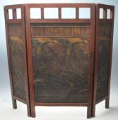 A 1920’s Arts & Crafts oak triptych fire screen guard  having articulated side panels with pierced