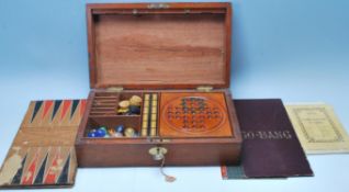 An early 20th Century wooden games compendium box being fully appointed with retro games to