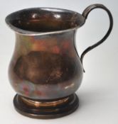 A 1940's Walker and Hall silver hallmarked christening cup of baluster form having a footed base