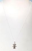 A stamped .925 silver pendant necklace in the shape of a child's doll having a .925 cable chain with