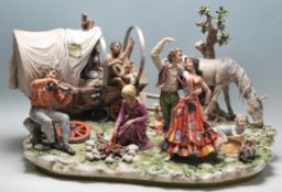A very large 20th century Capodimonte centrepiece figurine group 'The Gypsy Encampment by Sandro