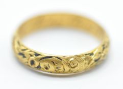 An early 18th Century gold memento mori mourning ring, the band being engraved with a skull and