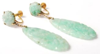 A pair of 9ct gold and jade screw back drop earrings having tear shaped drops carved with florals