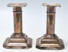 A pair of hallmarked sterling silver candlesticks with filled inner centres circular stems and set