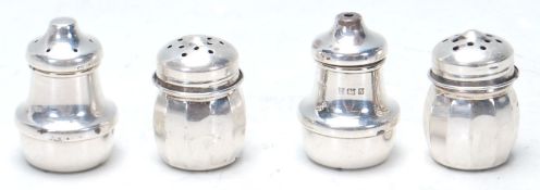 Two pairs of 20th Century silver hallmarked table cruets to include a salt and pepper shaker of