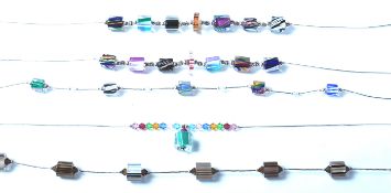 A group of five silver and glass bead necklaces each having silver clasps and spacers with