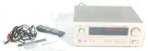 A Denon AVR-1803 Integrated AV surround receiver in gloss black with a remote controller. Comes