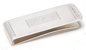 A vintage 20th Century silver hallmarked money clip having an engine turned panel to the front