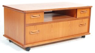 A vintage retro 1970's G Plan teak wood TV / entertainment unit having a central unit flanked by two